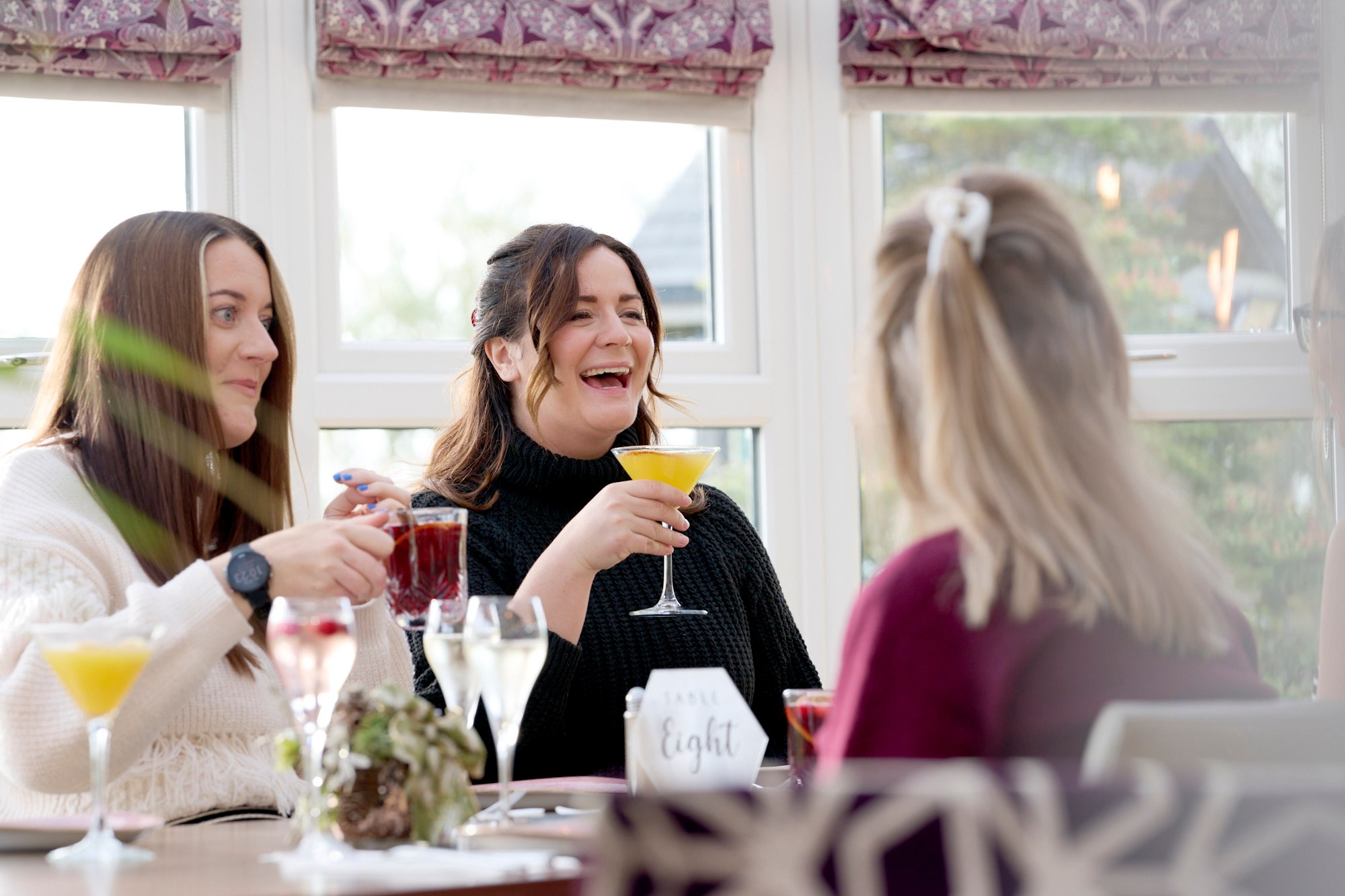 Ladies drinking and laughing at a Bottomless Brunch at the Conservatory restaurant