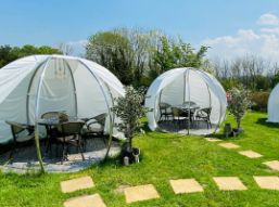 Outdoor dining pods at The Conservatory restaurant at The Melbreak Hotel