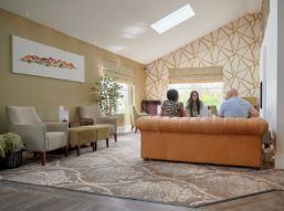 Group of people sitting on a sofa in the lounge at the Melbreak hotel