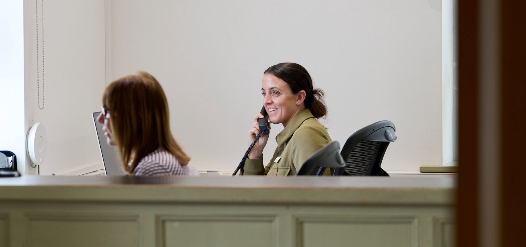 Reception staff on the phone at the Melbreak hotel